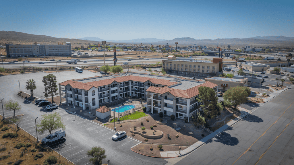 Aerial view of Motel 6 in Barstow, California, featuring modern amenities and a surrounding parking.