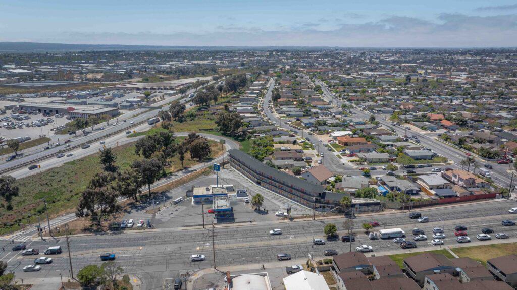 Aerial view of a busy urban highway and surrounding residential area in Los Angeles, California.