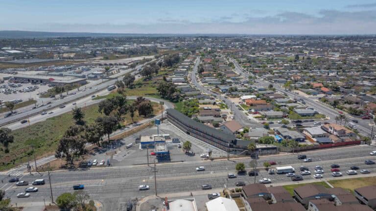 Aerial view of a busy urban highway and surrounding residential area in Los Angeles, California.